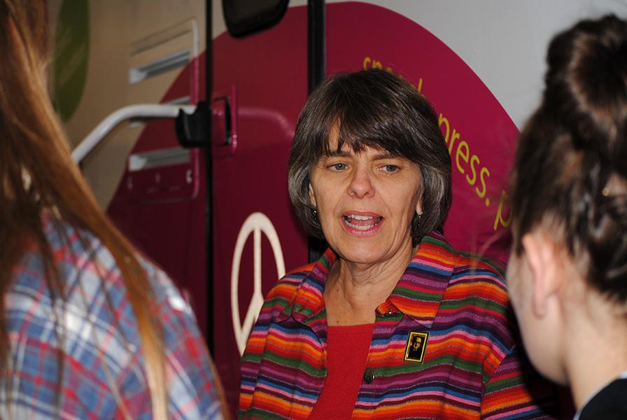 Mary Beth Tinker speaks to students outside her tour bus at the JEA Convention in Boston on Nov. 15. Tinker travels the country to spread her message about the importance of the First Amendment.