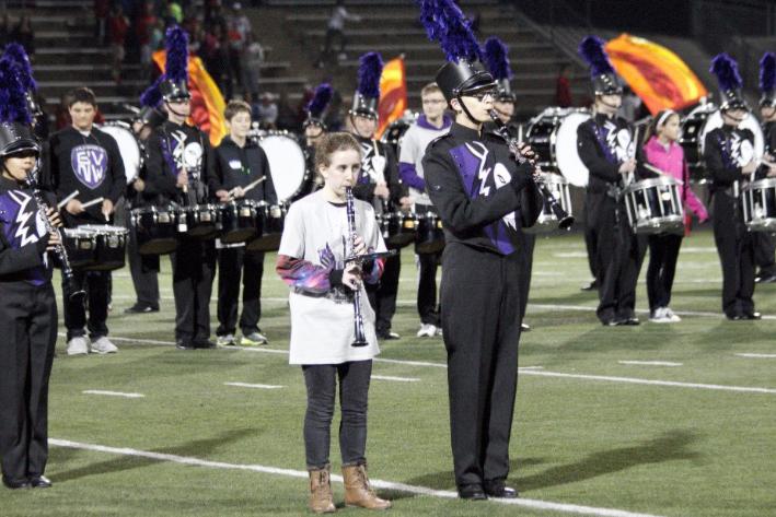 An eighth grader stands next to a member of the BVNW marching band during eighth grade band night.