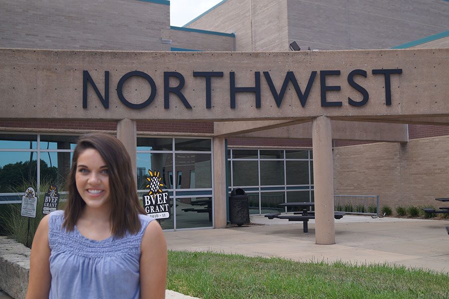 Senior Tatum Specht poses in front of the main entry at BVNW, wearing a tank top that meets the new guidelines. 