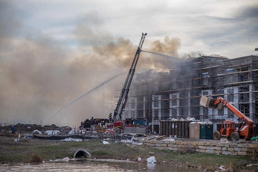 Fire fighters work to subdue the flames and smoke coming out of The Royale apartments.