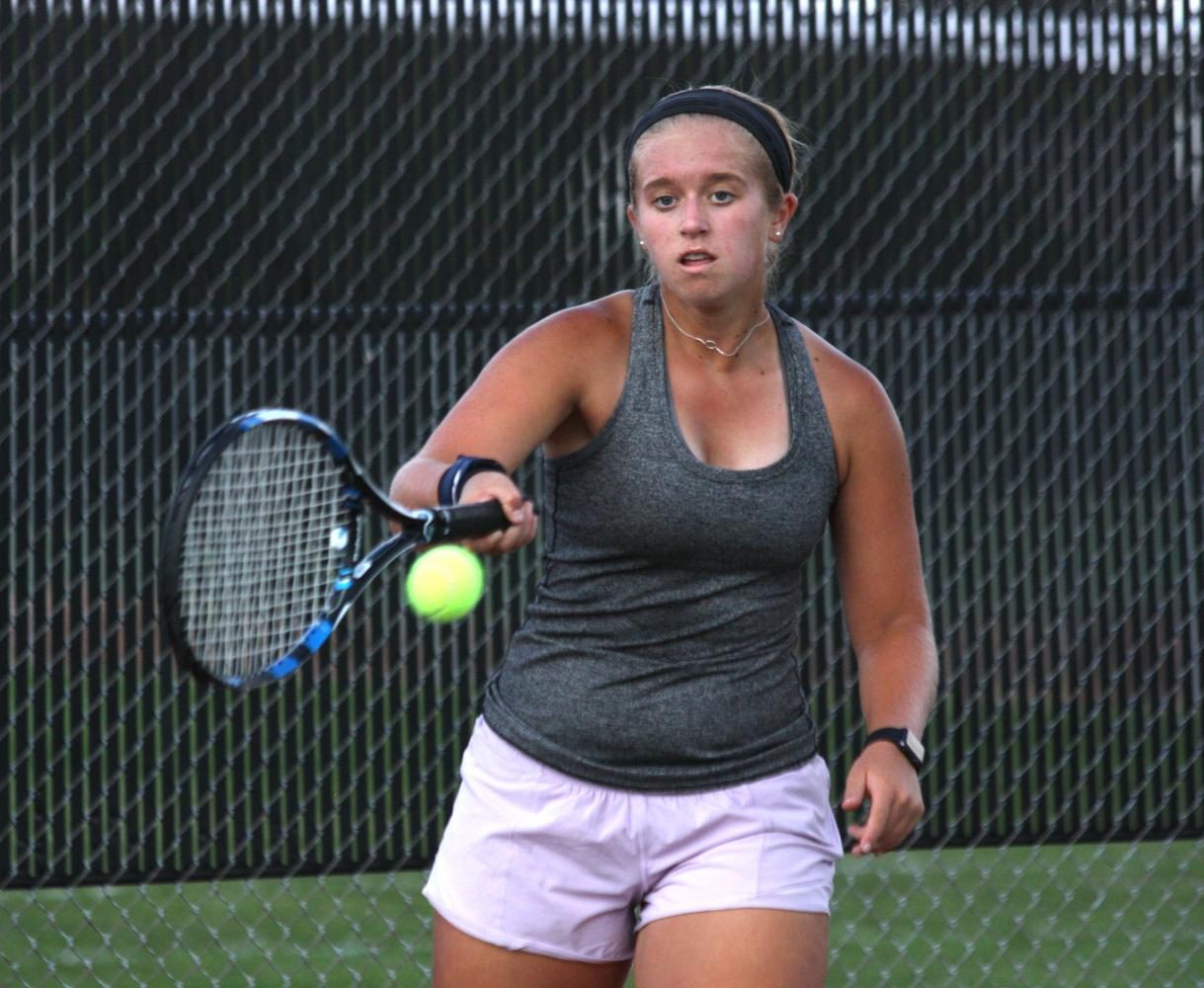 Sophomore Mia DeMarea returns a ball during her singles match against Olathe Northwest. 