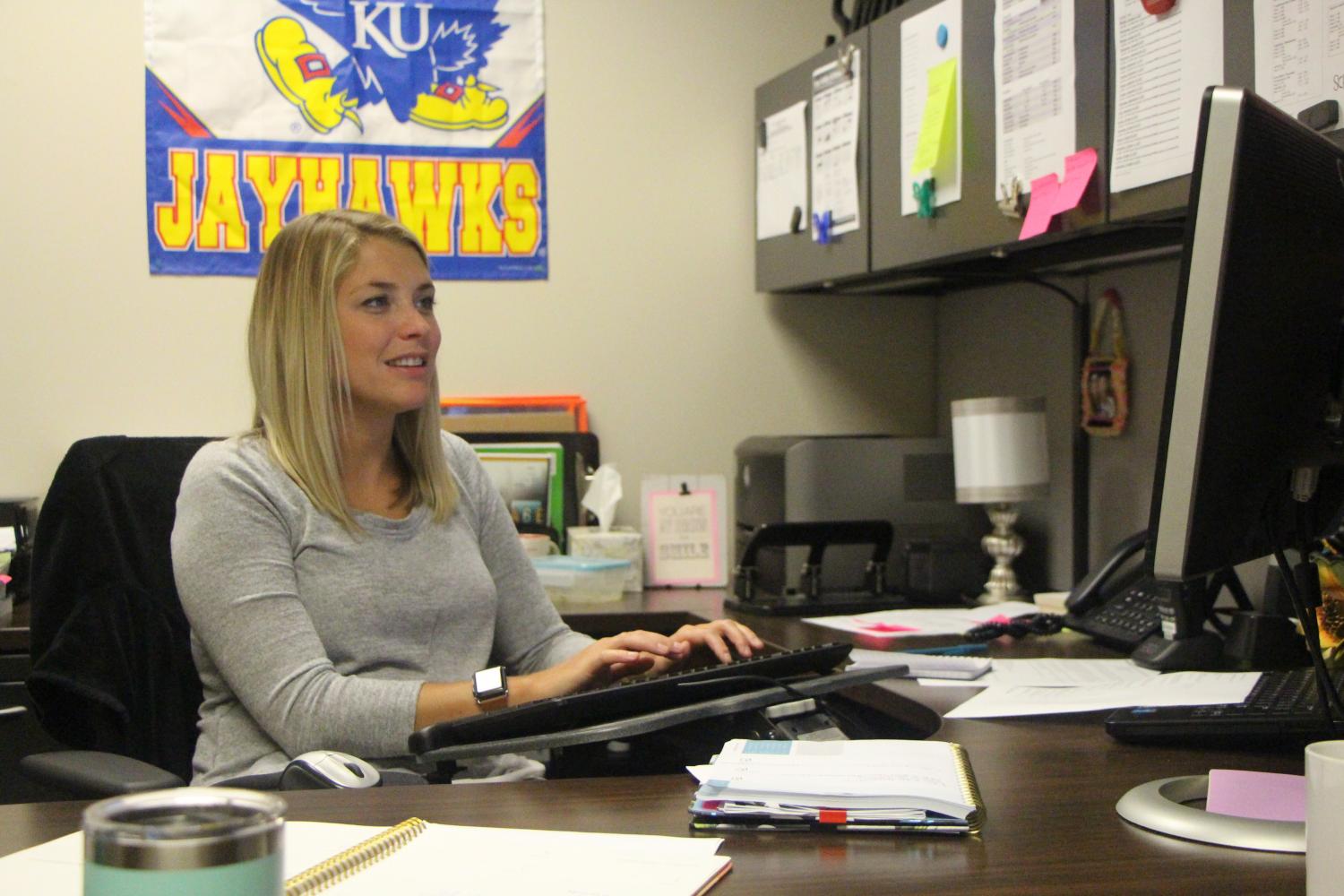 School interventionist Megan Geenens sits at her desk in her new office. "My favorite part about being an interventionist is being able to work closely with students who need academic help," Geenens said.