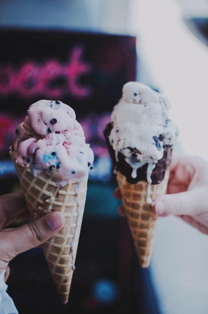 Single scoops of cotton candy (left) and Rock Chalk Jayhawk (right) in front of the Sweet Carolines shop.
