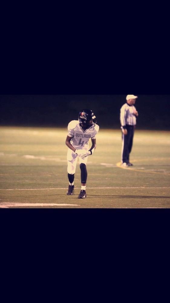 Sturdivant lines up at wide receiver in a game for his travel football team, the Outlaws.