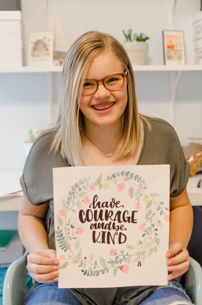 While holding a piece she created called have courage and be kind, senior Jessica Sarff expresses her creativity through calligraphy. 