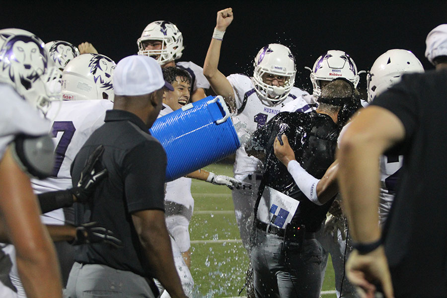 BVNW celebrates their first win of the season by dousing head coach Clint Rider with water at the DAC Sept. 15.