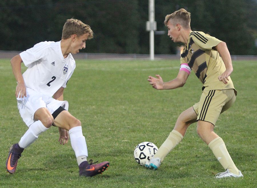 Senior Mitch Brill (2) defends a Lees Summit player at the DAC Sept. 14.