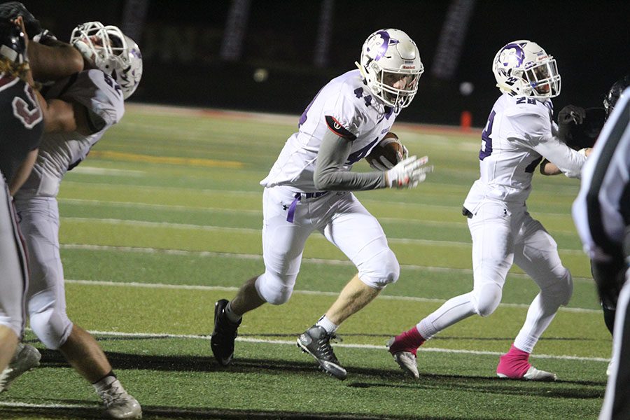 BVNW senior tight end Jackson Heath (44) runs up the middle to score a touchdown late in the fourth quarter against Lawrence High School Oct. 27 at LHS.