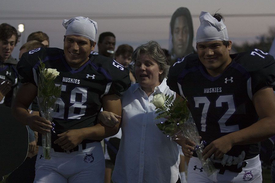 BVNW seniors Jared Cruz (58) and Josh Cruz (72) walk with their mom as they are recognized prior to the Senior Night game against Manhattan High School Oct. 20. 