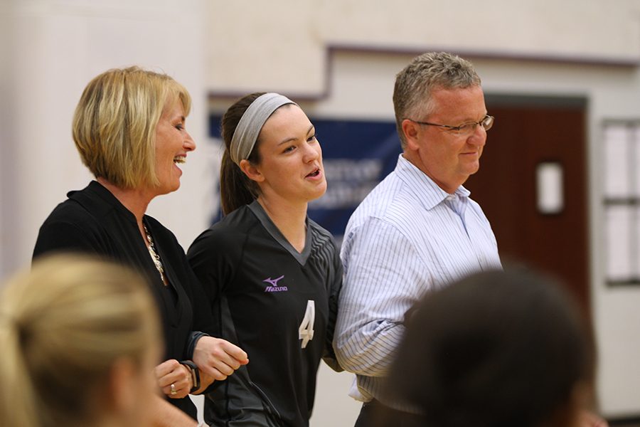 BVNW senior Laura Bredemeier (4) walks with her parents as she is recognized before the Senior Night game against Shawnee Mission West at BVNW Oct. 16.