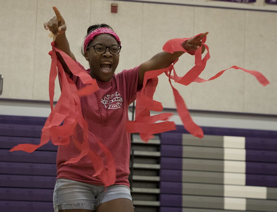 Junior Karen Murambadoro points to the stands during the junior skit on Class Color Day.