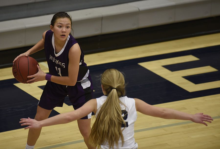 While trailing the Titans, junior Haley Shin squares up to find an open player against Lees Summit West on Dec. 15.