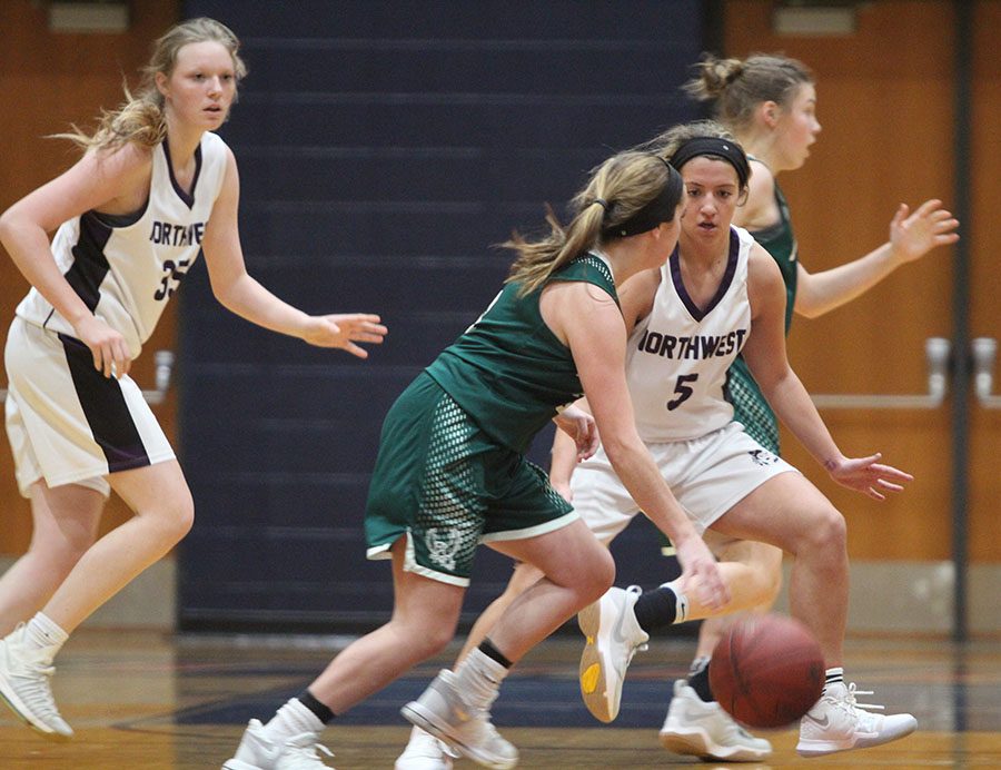 Senior guard Bridget Harrison (5) defends a Free State player while junior forward Madison Girard (35) looks on.