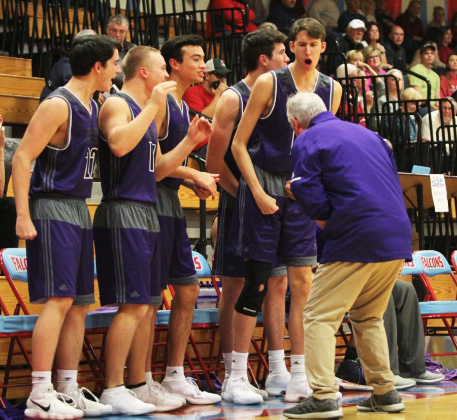 The Blue Valley Northwest bench celebrates after a made 3-pointer by senior guard Sam Ward during the fourth quarter.