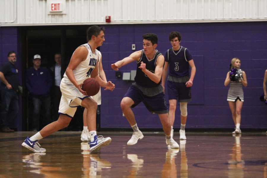 Blue Valley Northwest junior forward Matthew Chapman (50) attempts to steal the ball from an Olathe Northwest player during the first quarter of the Huskies matchup with the Ravens at Pittsburg High Jan. 19. The Huskies defeated the Ravens, 52-38.