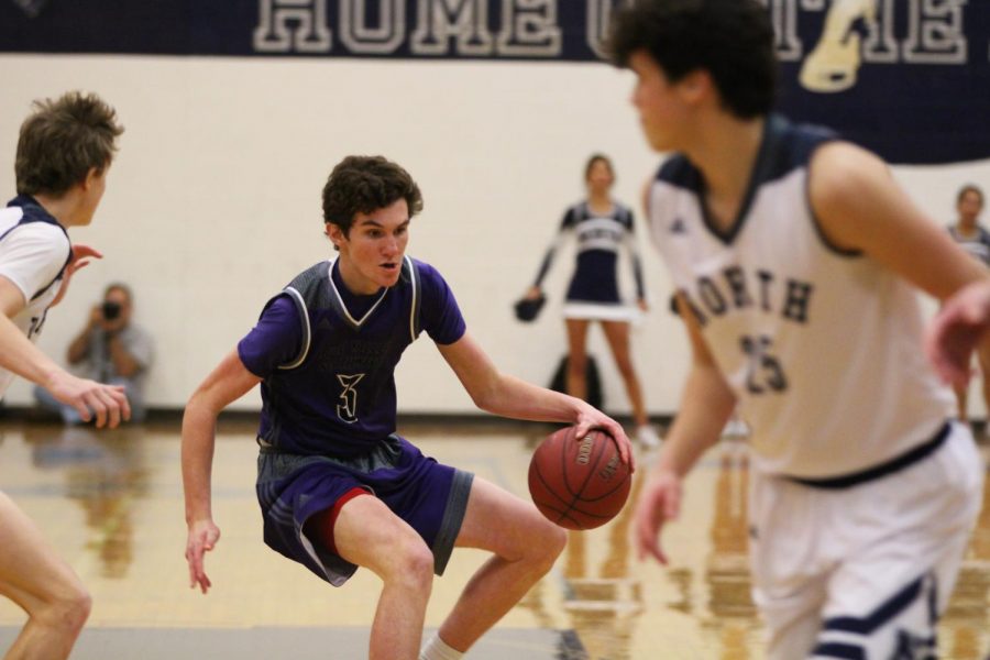 Blue Valley Northwest freshman guard Jack Chapman (3) dribbles the ball during the Huskies matchup with Blue Valley North at BVN Jan. 12. 