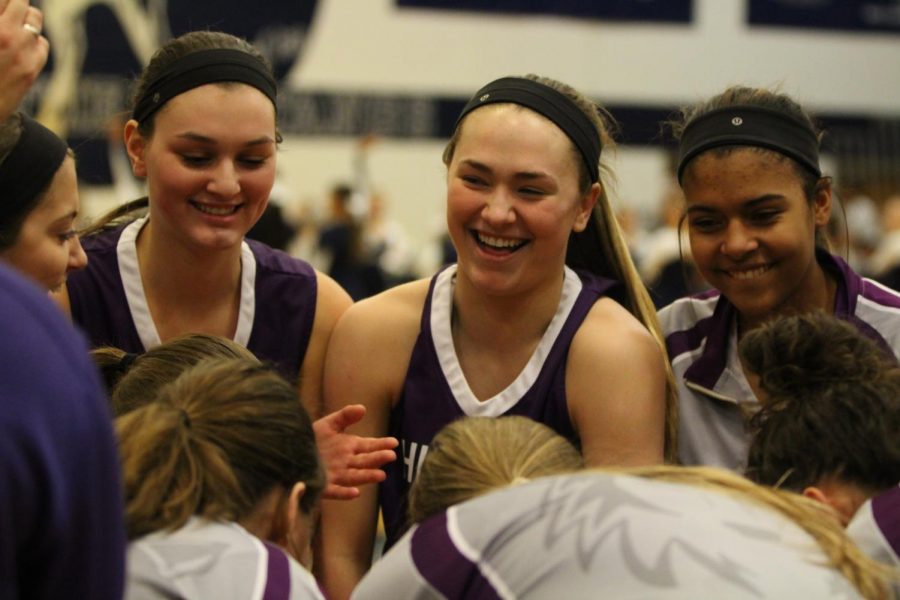 Blue Valley Northwest players laugh in a huddle during a timeout at BVN Jan. 12. 