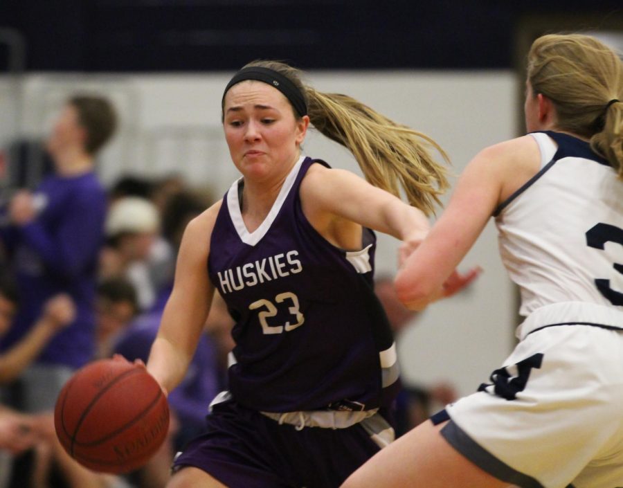 Blue Valley Northwest senior guard Kate Kaufman (23) dribbles the ball past a Blue Valley North defender at BVN Jan. 12. 
