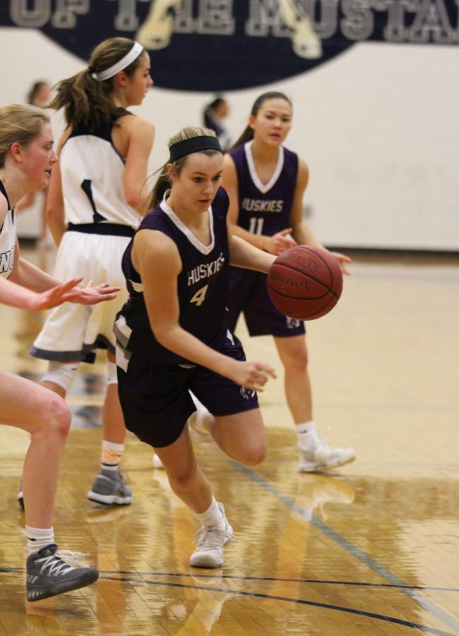 Blue Valley Northwest sophomore forward Grace Coble (4) drives the ball during the second half of the Huskies matchup with Blue Valley North at BVN Jan. 12. 