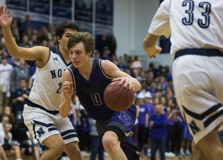 Blue Valley Northwest junior guard Christian Braun (0) drives the ball during the first half of the Huskies matchup with Blue Valley North at BVN Jan. 12. 