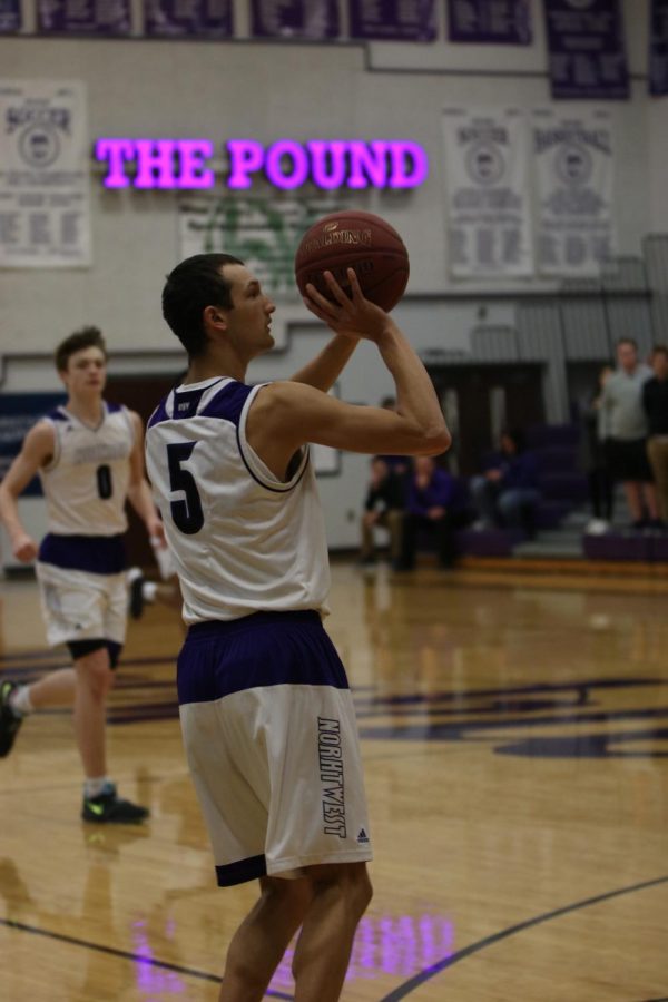 Blue Valley Northwest senior guard Sam Ward (5) attempts a 3-pointer during the first half of the Huskies matchup with East at BVNW Jan. 30. The Huskies defeated the Bears, 87-28.