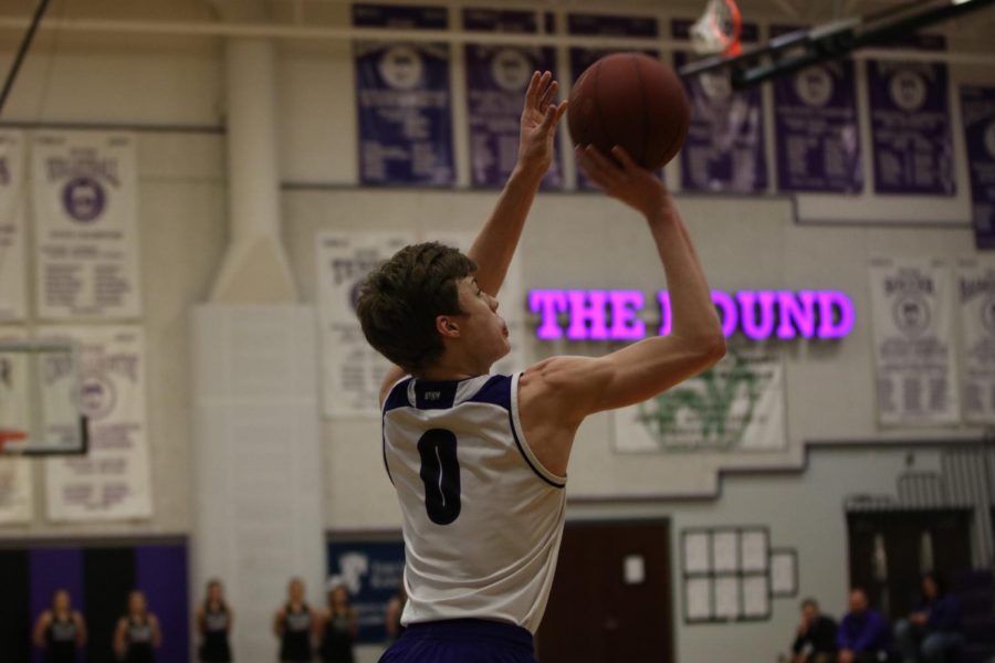 Blue Valley Northwest junior guard Christian Braun (0) goes up for a 3-point attempt in the first half of the Huskies matchup with East at BVNW Jan. 30. The Huskies defeated the Bears, 87-28.