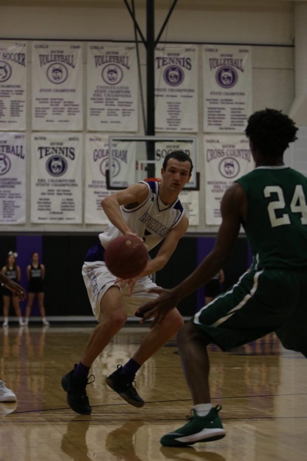 Blue Valley Northwest senior guard Sam Ward (5) passes the ball during the first half of the Huskies matchup with East at BVNW Jan. 30. The Huskies defeated the Bears, 87-28.