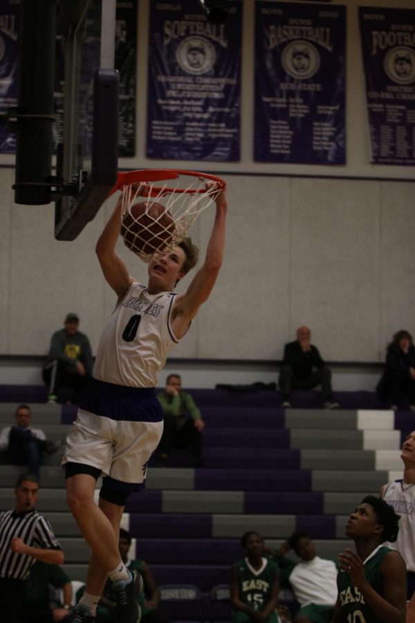 Blue Valley Northwest junior guard Christian Braun (0) dunks the ball during the second quarter of the Huskies matchup with East at BVNW Jan. 30. The Huskies defeated the Bears, 87-28.