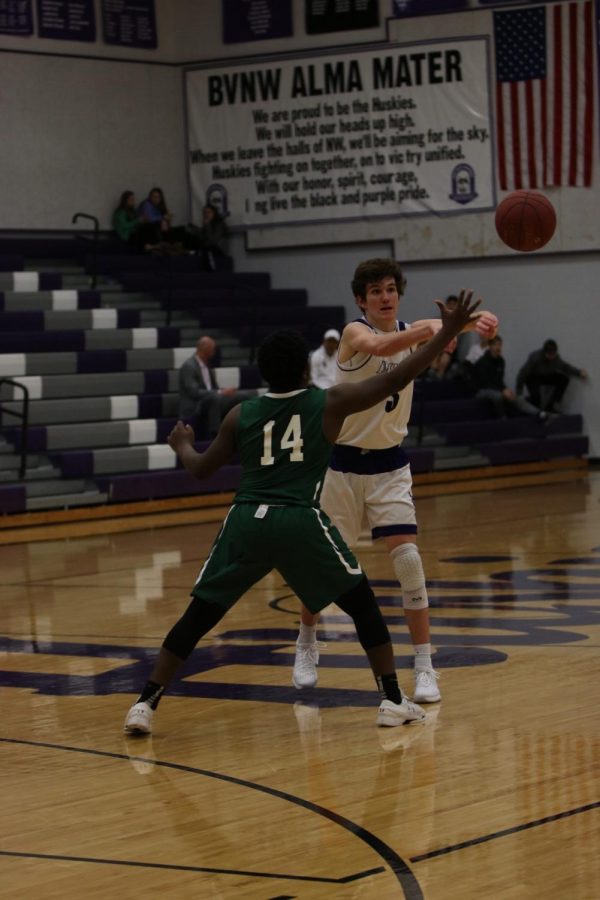 Blue Valley Northwest freshman guard Jack Chapman (3) passes the ball to a teammate during the second half of the Huskies matchup with East at BVNW Jan. 30. The Huskies defeated the Bears, 87-28.