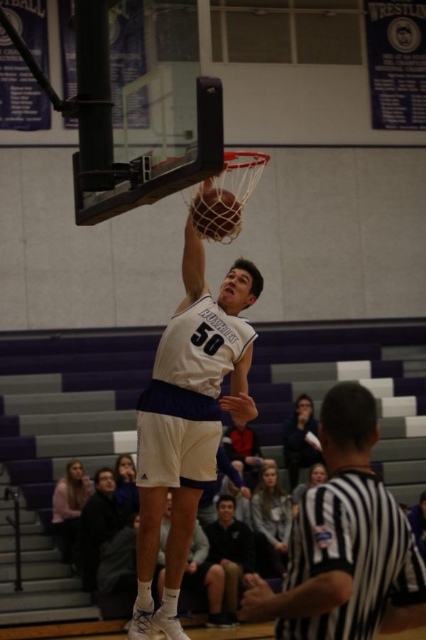 Blue Valley Northwest junior forward Matt Chapman (50) dunks the ball in transition during the second half of the Huskies matchup with East at BVNW Jan. 30. The Huskies defeated the Bears, 87-28.