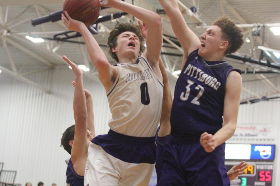 Blue Valley Northwest junior guard Christian Braun (0) goes up for a contested layup during the second half of the Huskies matchup with Pittsburg High at PHS Jan. 20. The Huskies defeated the Purple Dragons, 68-41. 