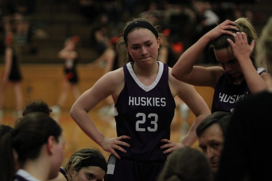 Blue Valley Northwest senior guard Kate Kaufman (23) looks into the huddle during a Huskies timeout during the Huskies substate matchup with Shawnee Mission Northwest at SMNW Feb. 27. The Huskies were defeated by the Cougars, 43-34.