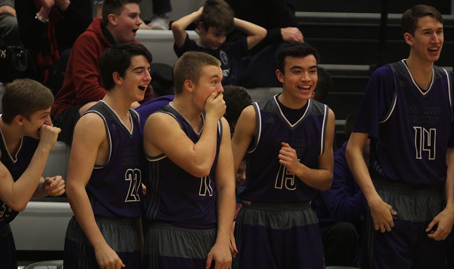 The+Blue+Valley+Northwest+bench+looks+on+in+awe+after+a+dunk+by+Joe+Pleasant+during+the+third+quarter+of+the+Huskies+matchup+with+Blue+Valley+Southwest+at+BVSW+Feb.+2.+The+Huskies+defeated+the+Timberwolves%2C+67-18.+
