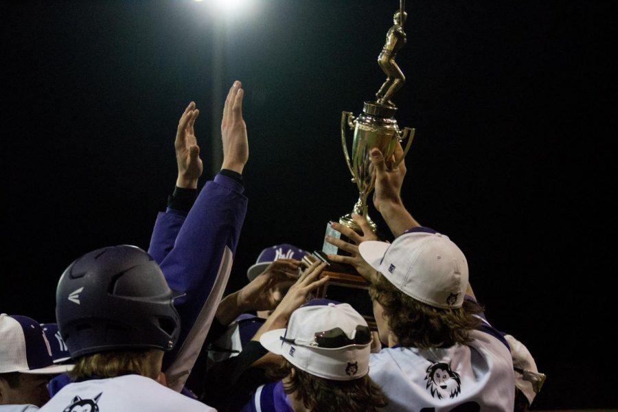 The Huskies hold up the trophy as champions of the Rob Jones Tournament, hosted by Olathe South. 