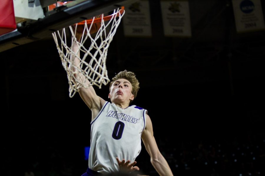 Blue Valley Northwest junior guard Christian Braun (0) extends for a dunk attempt during the second half of the Huskies matchup with Derby at Charles Koch Arena. The Huskies defeated the Panthers, 82-61.