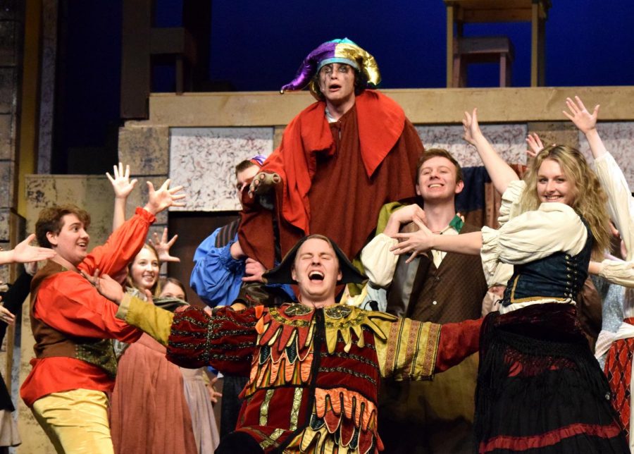 The cast of the musical, Notre Dame, are seen crowded around seniors Kyle Feather and Griffin Leander.