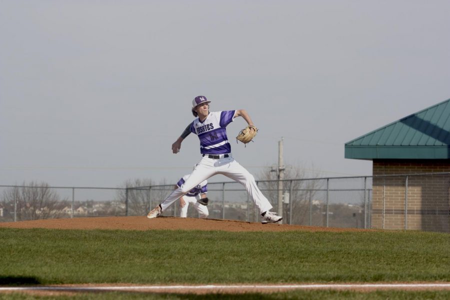 Senior Max Abramovich pitches during the Huskies matchup with Blue Valley West at the DAC April 24. The Huskies defeated the Jaguars, 10-3.