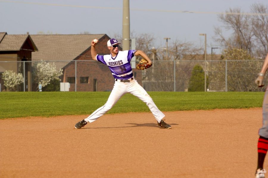 Sophomore Ryan Callahan throws to first base during the Huskies matchup with Blue Valley West at the DAC April 24. The Huskies defeated the Jaguars, 10-3.