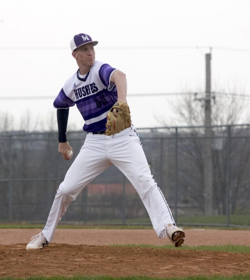 Senior Johnny Rubeo throws a pitch during the sixth inning of the Huskies matchup with Blue Valley West at the DAC April 24. The Huskies defeated the Jaguars, 10-3.