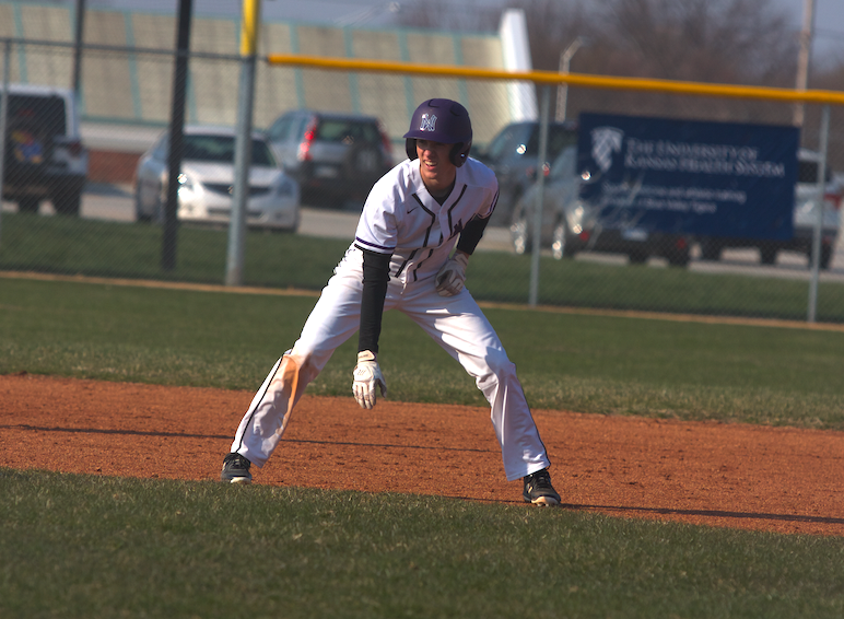 Sophomore Matt Miller leads off of second base during the Huskies matchup with Blue Valley at BVHS April 10. The Huskies defeated the Tigers, 15-10. 