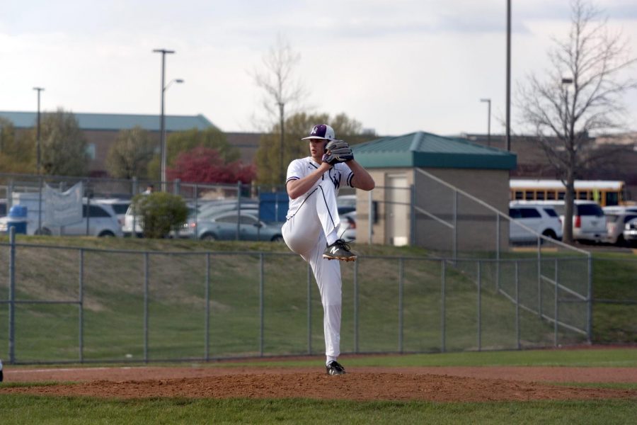 Senior Will Dennis winds up for a pitch during the Huskies matchup with Blue Valley North April 26. The Huskies defeated the Mustangs, 12-3. 