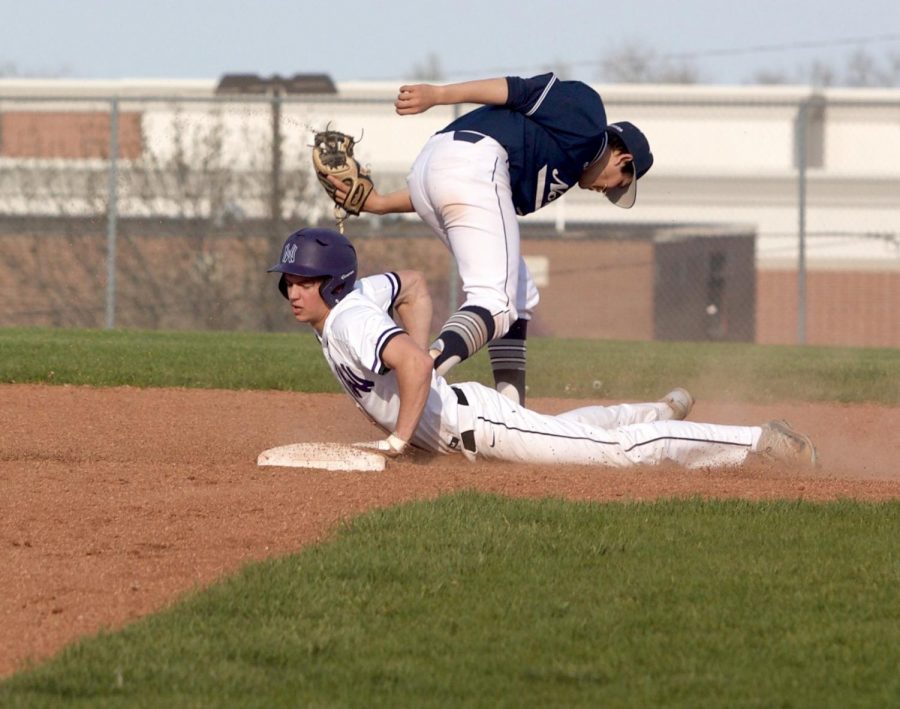 Senior Jack MacGee steals second base during the bottom of the sixth inning of the Huskies matchup with Blue Valley North April 26. The Huskies defeated the Mustangs, 12-3. 