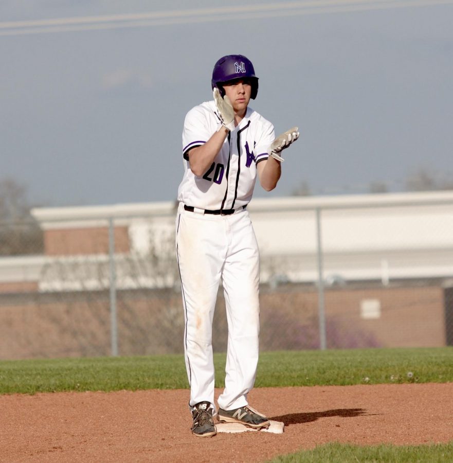 Junior Sean Roseborough claps after an RBI double in the bottom of the sixth inning of the Huskies matchup with Blue Valley North April 26. The Huskies defeated the Mustangs, 12-3. 