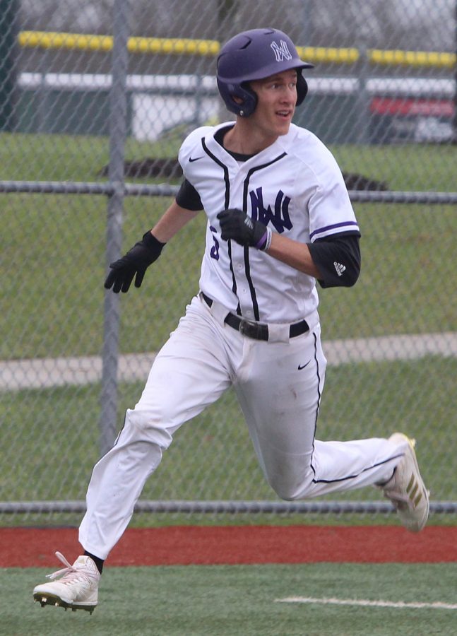 Senior right fielder Jack Beckley watches senior Clayton Leathers single, as he scores the second run of the game for the Huskies. The Huskies defeated Jefferson City 3-1 at Lawrence Free State April 21.