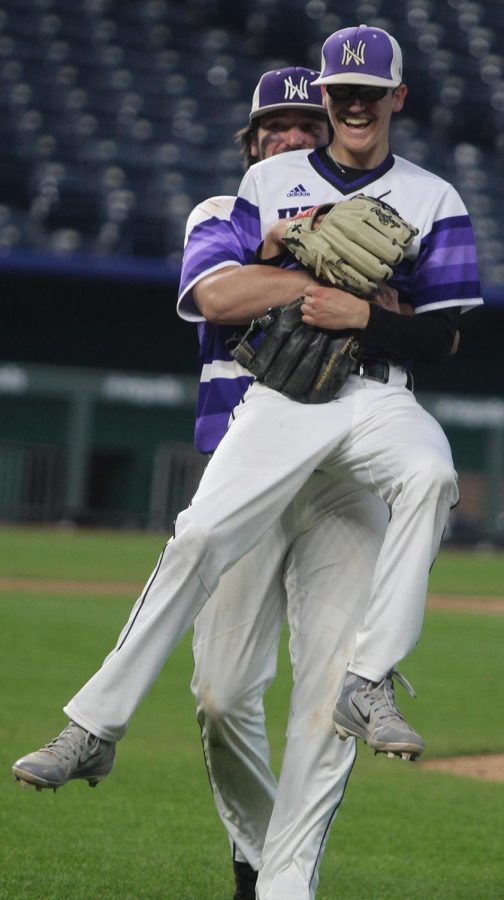 Senior Josh Fiene hugs senior Scott Duensing after Duensing completed his complete game during the Huskies matchup with Summit Christian Academy at Kauffman Stadium April 21. The Huskies defeated the Eagles, 6-2. 