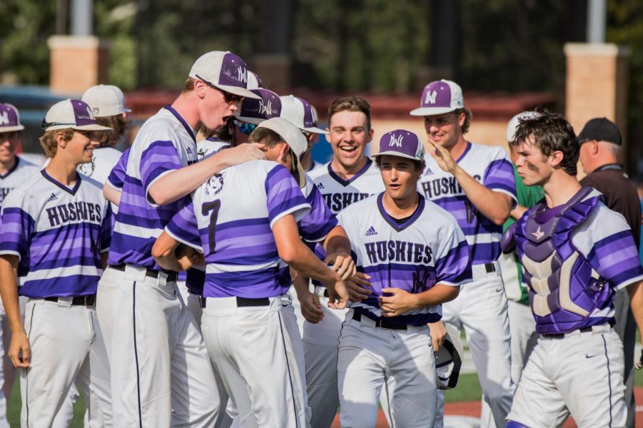 Members of the Huskies celebrate with senior Scott Duensing (7) after Duensing clinched the Huskies place in Saturdays state championship game. 