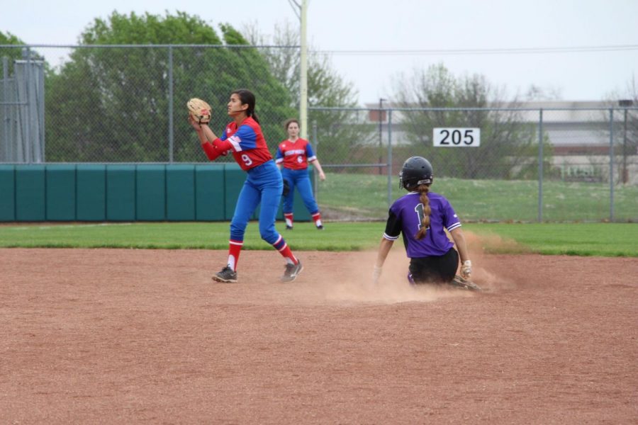 Sophomore Audrey Warner slides safely into second base during the first game of the Huskies doubleheader against Bishop Miege May 1. The Huskies defeated the Stags, 12-1 and 15-0 in the doubleheader.