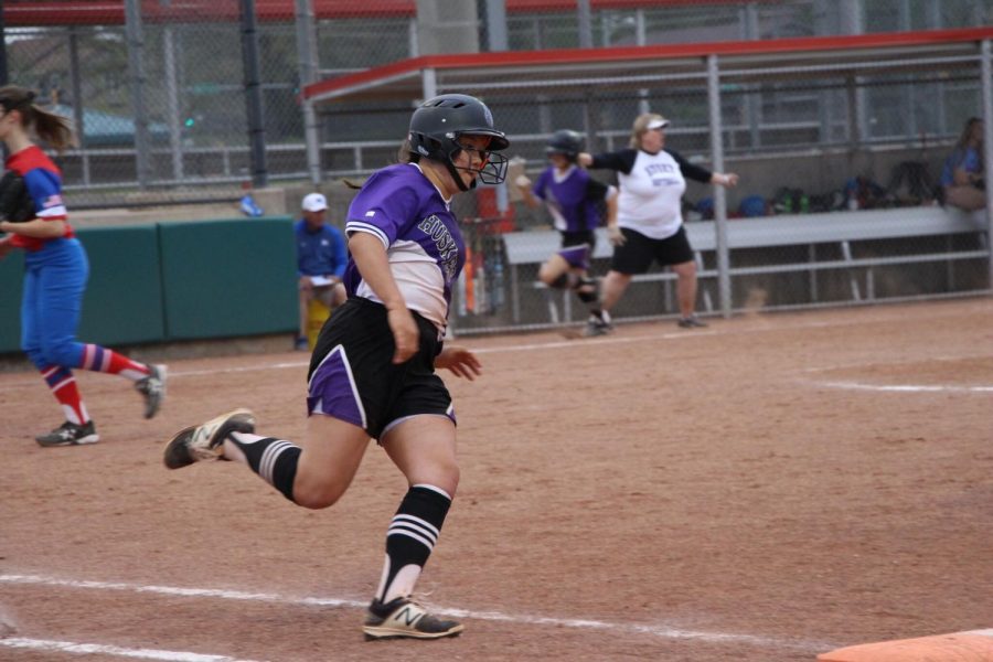 Freshman Olivia Shin runs to first base during the first game of the Huskies doubleheader against Bishop Miege May 1. The Huskies defeated the Stags, 12-1 and 15-0 in the doubleheader.