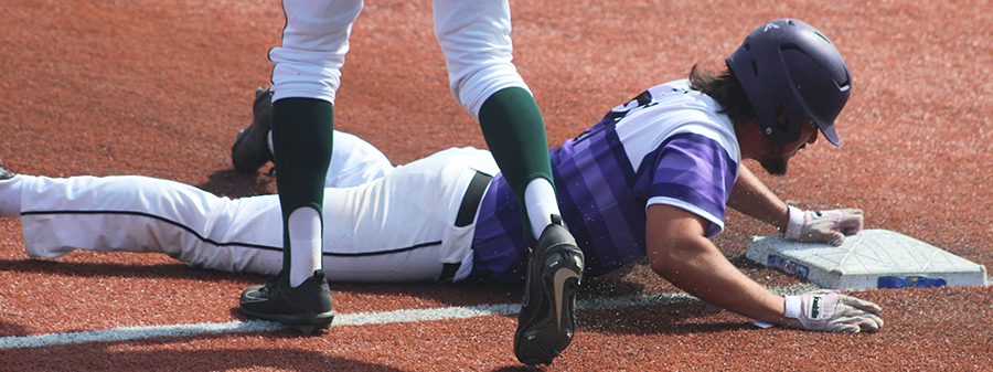 Senior third baseman Josh  Fiene slides into third base against Derby High School at Hoglund Ballpark May 25. The Huskies defeated the Panthers 4-3.