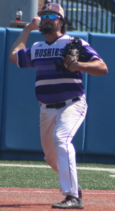 Senior third baseman Josh Fiene throws the ball to first base for an out against Blue Valley High School at Hoglund Ballpark May 26. The Huskies were defeated by the Tigers 1-0 to finish second at the state tournament.